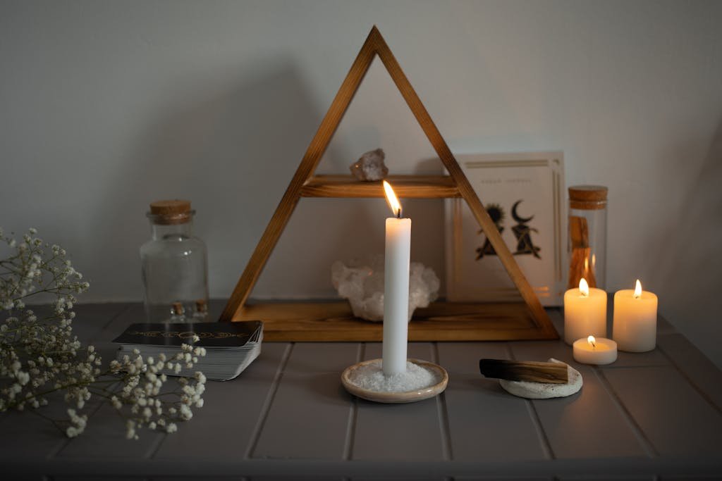 A serene spiritual setup featuring candles, crystals, and tarot cards arranged for meditation.